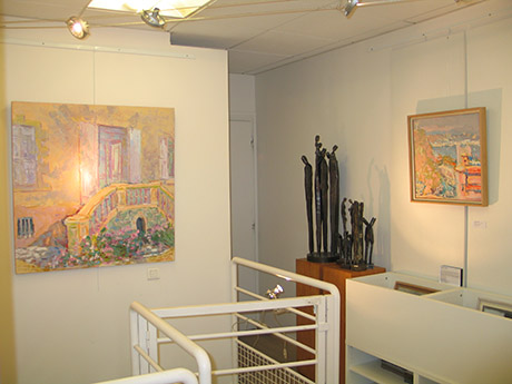 Inside the gallery both paintings and sculptures stand together.